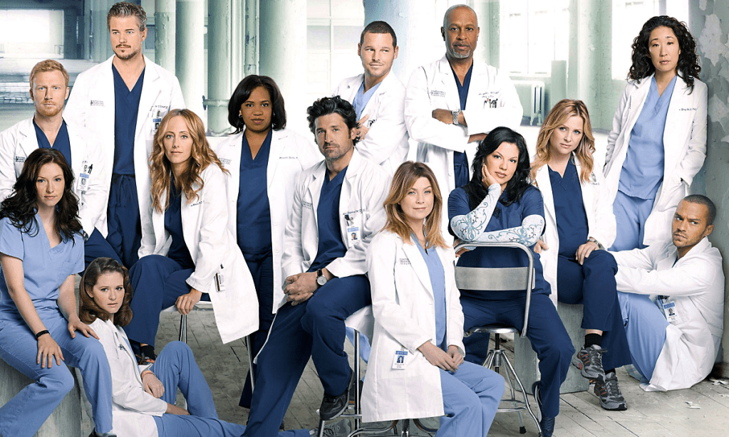 The cast of Grey's Anatomy look toward the camera