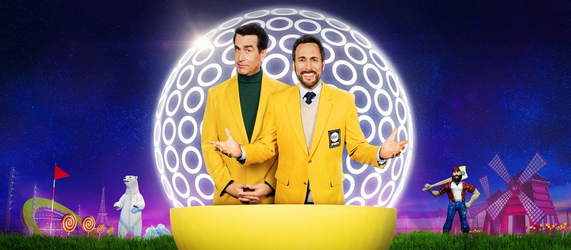 Rob Riggle and Joe Tessitore standing in front of a giant golf ball.