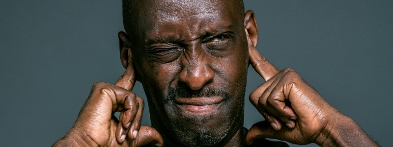 A man plugs his ears
