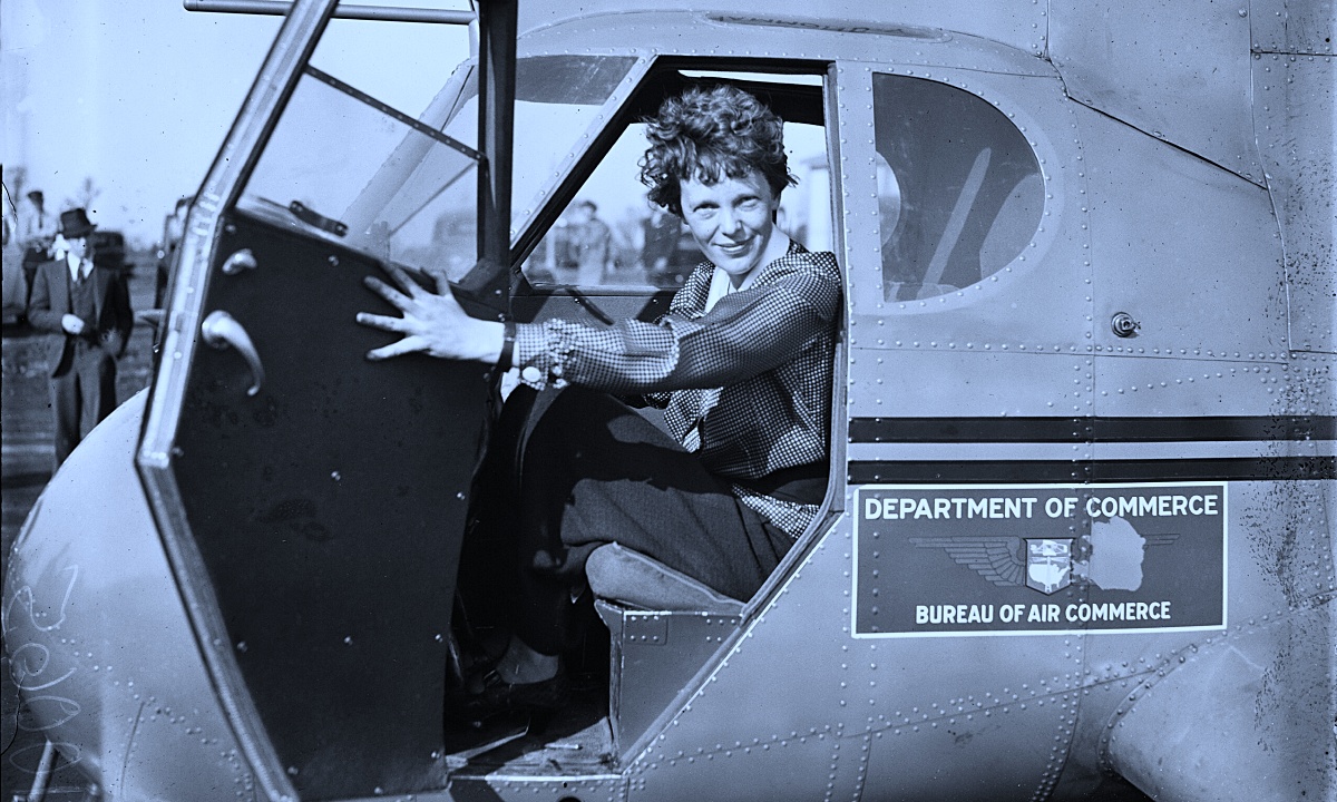 Amelia Earhart in the cockpit of a plane.