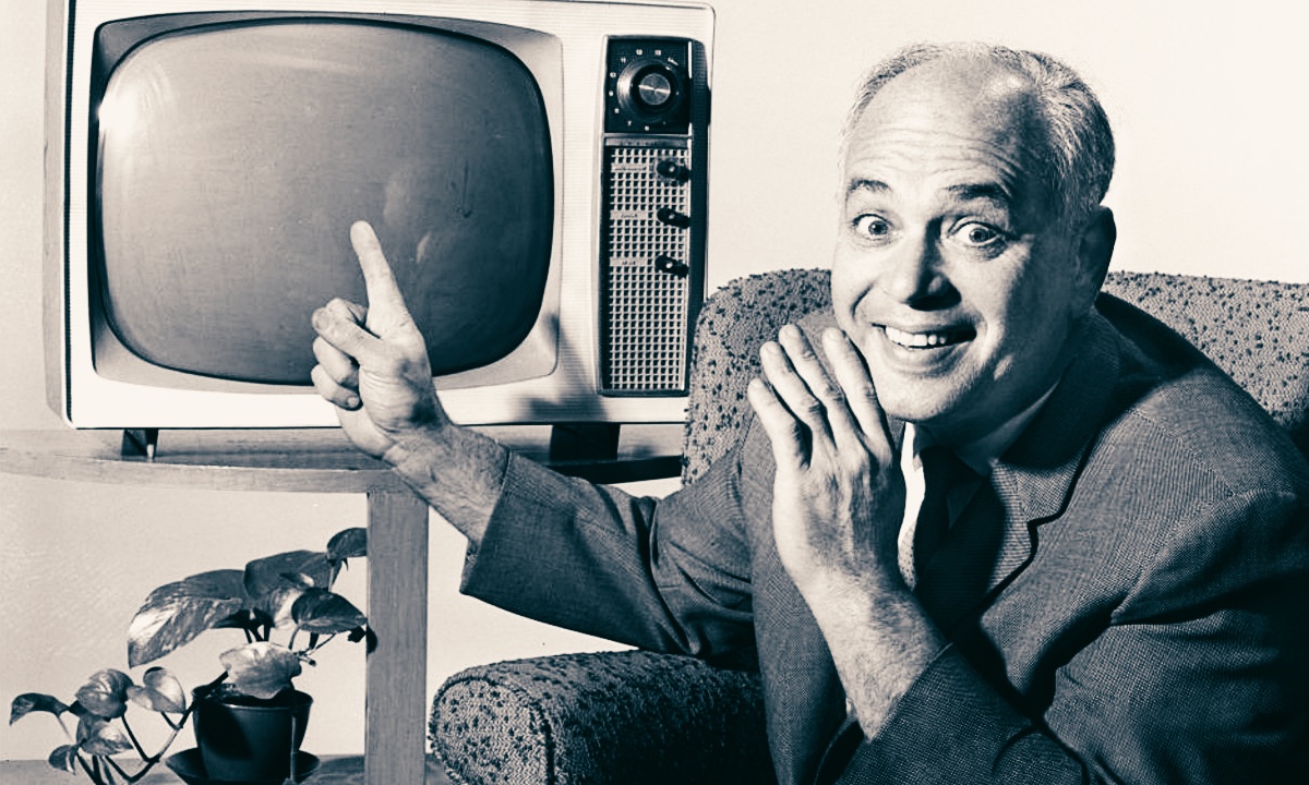 Allen Funt pointing at a TV