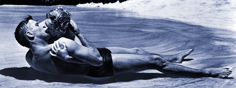 A man and woman kiss on the beach in the movie, "From Here to Eternity"
