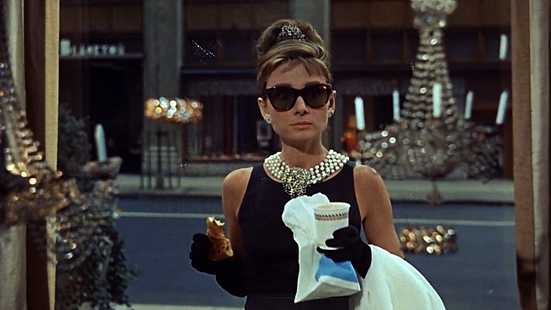 Audrey Hepburn looking at jewelry at Tiffany's through a window in the movie "Breakfast at Tiffany's"