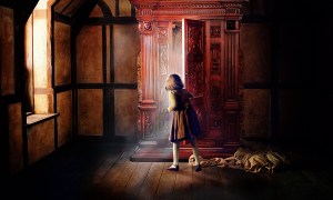 A girl looks inside a wardrobe and a bright light shines out.
