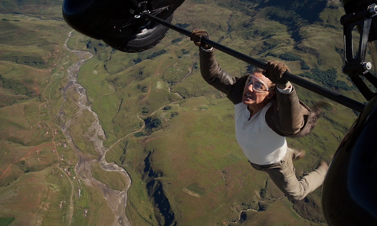 Tom Cruise hanging onto a plane with just his hands.