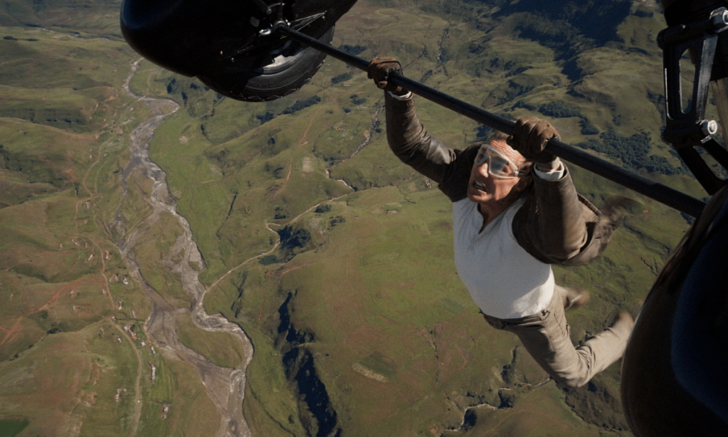 Tom Cruise hanging onto a plane with just his hands.