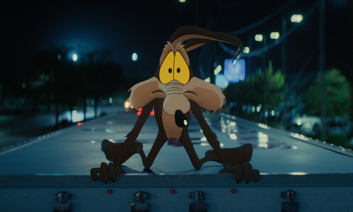 Wile E. Coyote riding on top of a semi truck
