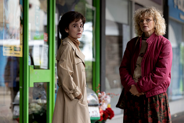 Shirley Henderson and Maxine Peake stand outside of a shop and talk in "I Swear"