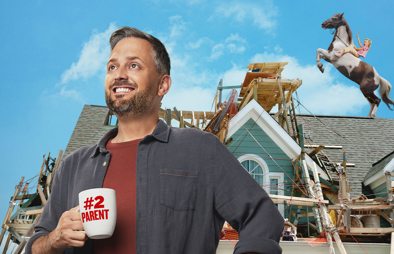 A man looks confidently with coffee cup in hand in front of his house which is under construction - "The Breadwinner" movie 