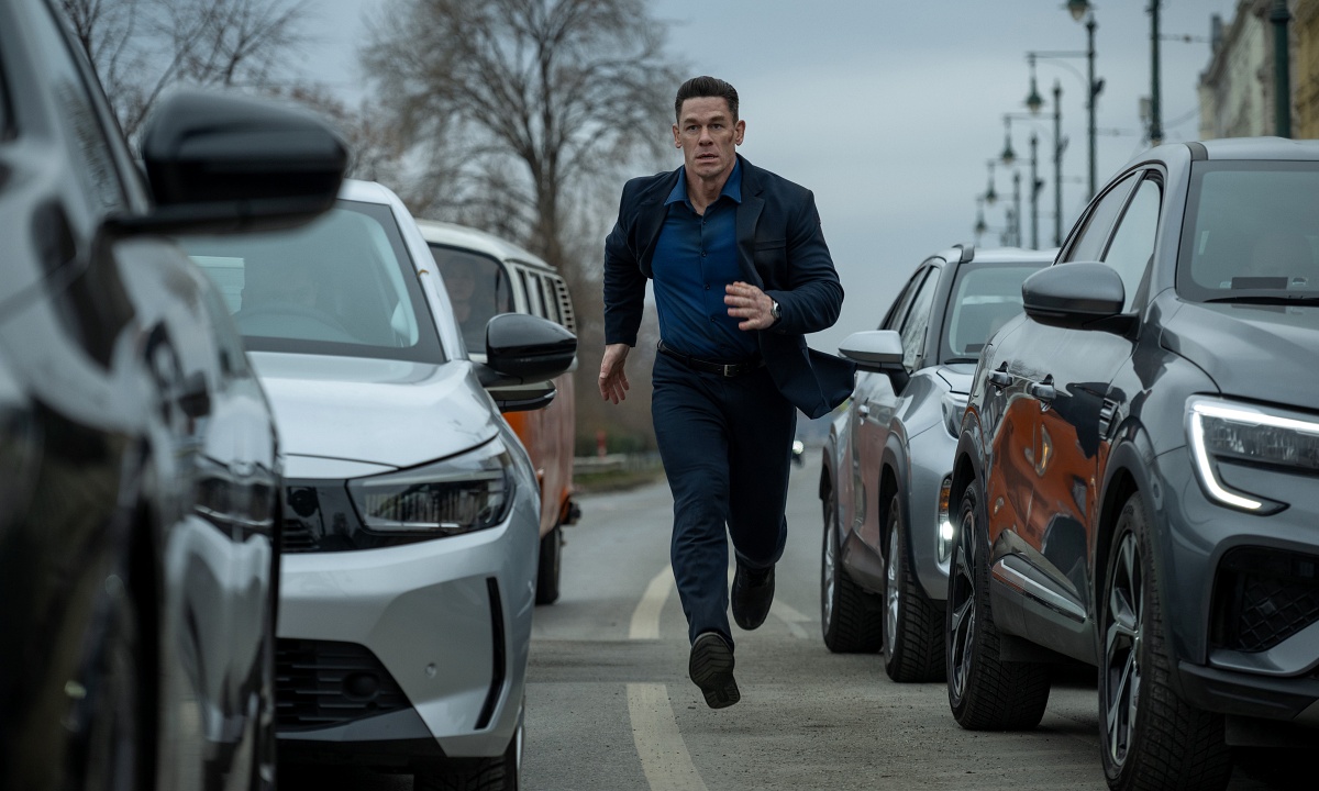 A man running in the middle of traffic,