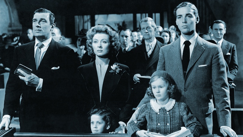A family standing together solemnly in church