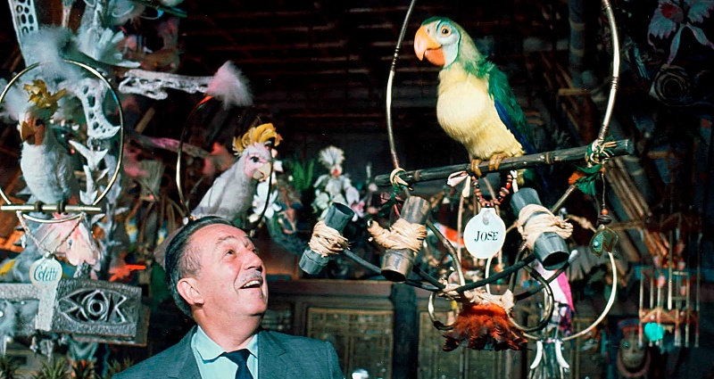 Walt Disney having a conversation with a bird in the Enchanted Tiki Room in Disneyland.