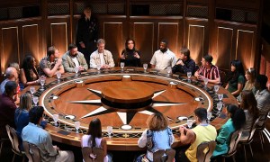 A group of contestants sitting at a round table for the show "The Traitors"